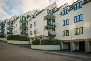 an apartment building with balconies on a street at Rigg & Rest Apartment - Bowness in Bowness-on-Windermere