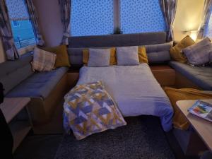 a small bedroom with a bed and a couch at elbry in Heysham