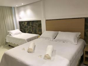 Кровать или кровати в номере Suites Amma Noronha