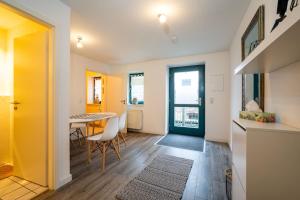a kitchen and dining room with a table and chairs at Bördeapartment 3 in Vahldorf
