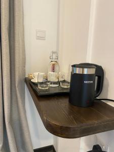 a coffee maker and glasses on a wooden shelf at chillax Thoddoo in Thoddoo