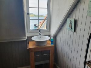 a sink in a room with a window at Argyll Mansions Penthouse in Oban