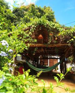 a hammock in front of a house with plants at Tinto Hostel in Barichara