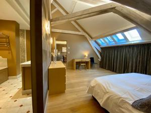 a bedroom with a bed in a room with a window at Demeure Saint Louis Historic manor, City 700m, parking,A C,Clim,WIFI, heated pool, city view in Carcassonne +37 photos