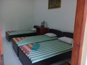Letto o letti in una camera di Dinimuthu Rest Inn