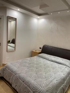 a bedroom with a bed and a mirror on the wall at B&B Rossini Luxury 2 in Cosenza +55 photos