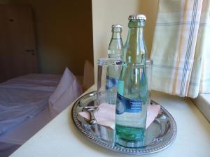 two glass bottles on a tray on a table at Hotel Wilhelmshof in Ribnitz-Damgarten