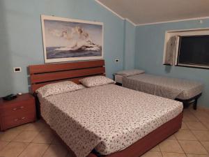 Posteľ alebo postele v izbe v ubytovaní Iris Casa Vacanze