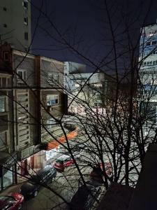 a view of a city street with cars and buildings at Dni apartment in Bucharest