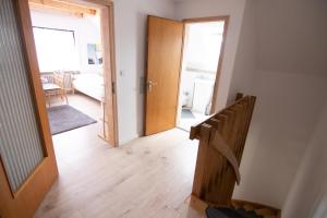 a hallway with a staircase and a door to a living room at Schönes Familienzimmer in Neumarkt in der Oberpfalz