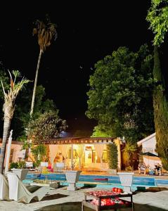 a resort with a swimming pool at night at La Casita Inn Bustamante in Bustamante