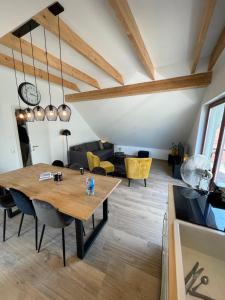 a dining room with a wooden table and chairs at Penthouse Apartment in Weener