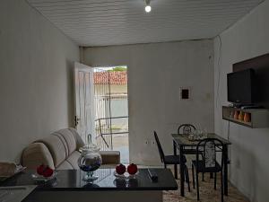 a living room with a table and a television at ApartofFerdi in São Luís