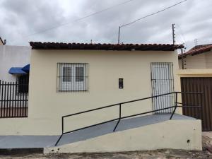 a white house with a staircase in front of it at ApartofFerdi in São Luís