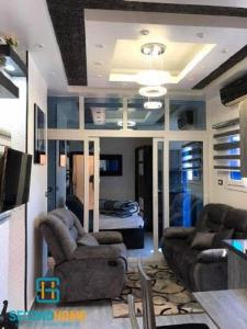 a living room with two couches and a television at Oasis resort-Nice Condo -B31-Al Ahyaa - Hurghada in Hurghada