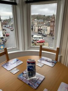 a table with a view of a city from a window at Home with a view in Moffat