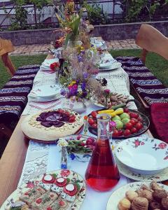una mesa larga con platos de comida. en Podrum Miljević, en Ledinci