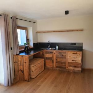 a kitchen with a sink and wooden cabinets at Bergchalet Prantach in San Martino