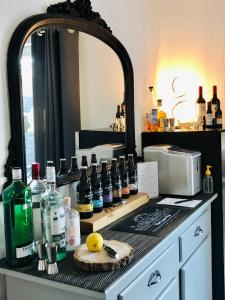 a counter with a mirror and a bunch of bottles on it at Distant Hills Guest House in Spean Bridge