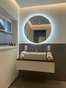 a bathroom with a sink and a mirror at DRIEHOF LifeStyle Classic Apt 2 in Tecklenburg