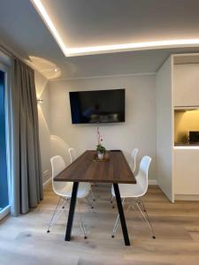 a dining room with a table and white chairs at DRIEHOF LifeStyle Classic Apt 2 in Tecklenburg