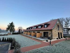 a large stone house with a red roof at DRIEHOF LifeStyle Classic Apt 2 in Tecklenburg