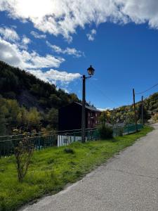 a street with a fence and a light pole at Neverending Nature León in Tremor de Arriba