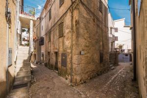 an alley in an old town with buildings at Rustica in Vrbnik +13 photos