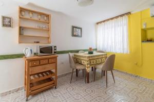 a room with a table and chairs and a television at Rustica in Vrbnik
