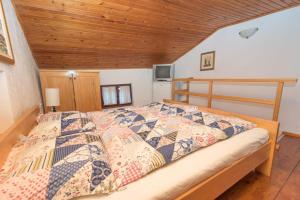 a bed in a room with a wooden ceiling at Rustica in Vrbnik