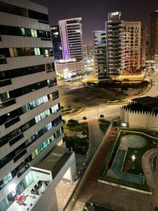 a view of a city at night with tall buildings at Dubai Backpackers in Dubai