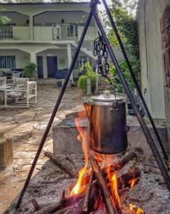 a pot sitting on top of a fire at La Casita Inn Bustamante in Bustamante