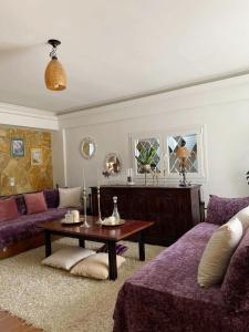 - un salon avec des canapés violets et une table dans l'établissement Villa Anasandra - 3 bedroom Villa, à Kompítsion