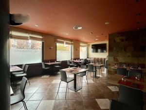 a dining room with tables and chairs in a restaurant at Hotel Yerri in Estella