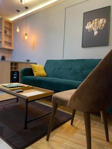- un salon avec un canapé vert et une table basse dans l'établissement BW Luxury Apartment Bijeljina, à Bijeljina