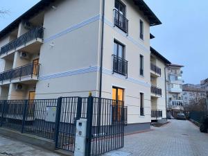 a white building with a fence in front of it at GLAM APARTMENTS Lipatti near Iulius Mall in Timişoara