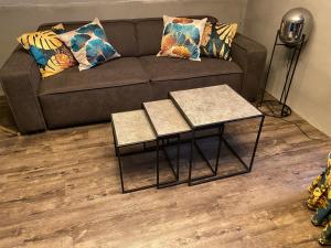 a living room with a couch and two tables at W-8 - Moderne Ferienwohnung mit viel Charme & spektakulärem Blick in Sandebeck