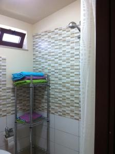a bathroom with a shower and two towel racks at Villa Rosa in Porto Empedocle