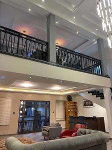 a living room with a staircase in a house at AlanVal Suites in Accra