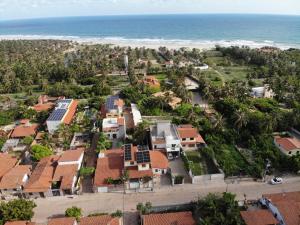 an aerial view of a house and the beach at Ruan Beach in Guajiru