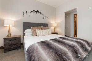 ein Schlafzimmer mit einem Bett mit einem Bergsticker an der Wand in der Unterkunft Heavenly Mountain Hideaway, Pool, Hot Tub in Radium Hot Springs + 27 Fotos