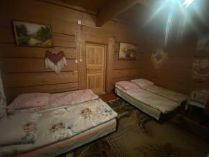 a bedroom with a bed and a desk at Góralskie Pokoje in Witów