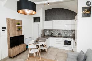 a kitchen with a table and chairs in a room at AH Poštová in Košice +20 photos