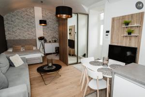 a living room with a couch and a table with chairs at AH Poštová in Košice