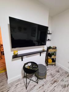 a living room with a large flat screen tv on a wall at Beautiful Apartment - up to 4 guests - Leicester City Centre . Free WIFI in Leicester