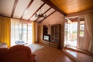 a living room with a couch and a tv at House Maca in Palit