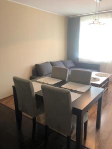 a dining room with a table with two laptops on it at Apartament Elbląg Wyczółkowskiego 10 in Elblag
