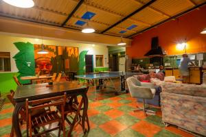 a living room with ping pong tables and chairs at Del Barcito Hostel and Suites in Punta del Este