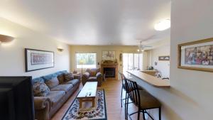 a living room with a couch and a table at Kokopelli Dream #3251 in Moab