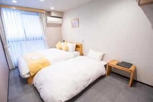 Letto o letti in una camera di Stay SAKURA Kyoto Shijo Karasuma